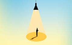 Man stands under light