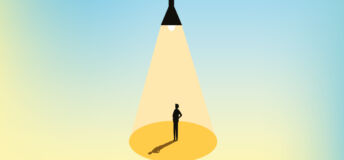 Man stands under light