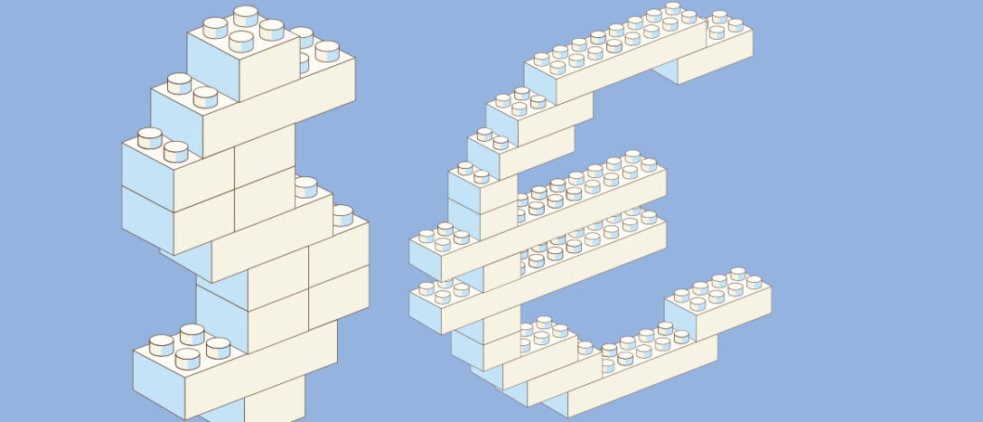 Toy building blocks in the shape of a dollar sign and euro sign
