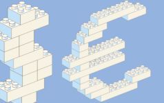 Toy building blocks in the shape of a dollar sign and euro sign